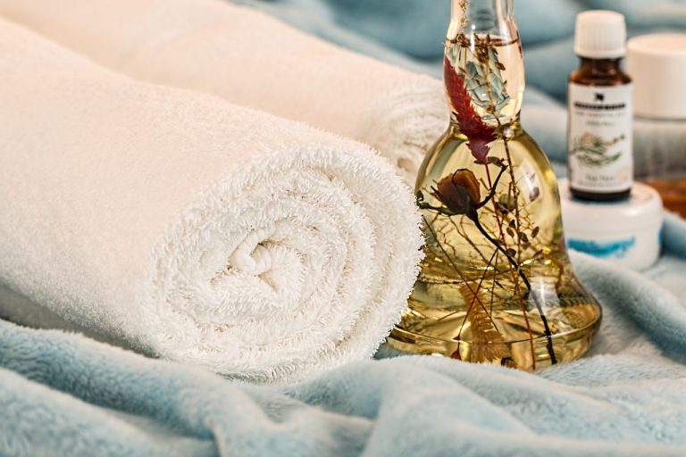 Deep tissue therapy elements oils, towel and roses